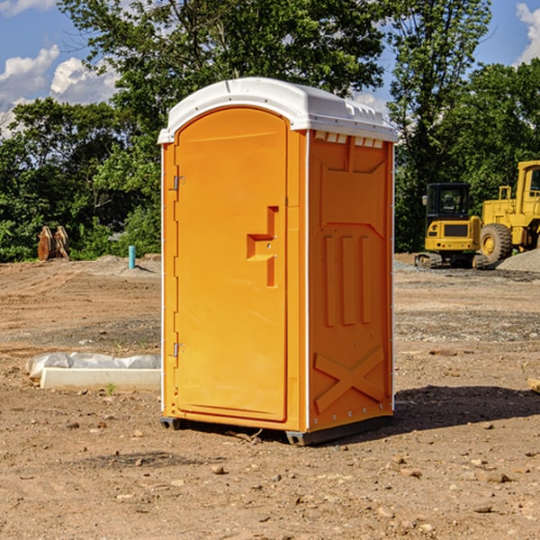 what is the cost difference between standard and deluxe portable restroom rentals in Wallis